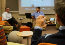 Picture of an iPhone taking a picture of two guest speakers