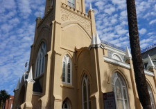 Tall church with a cloudy blue sky as the backdrop